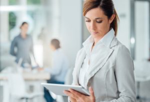 Professional business woman using a digital tablet