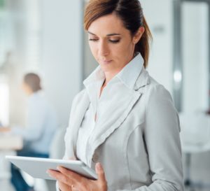 Professional business woman using a digital tablet